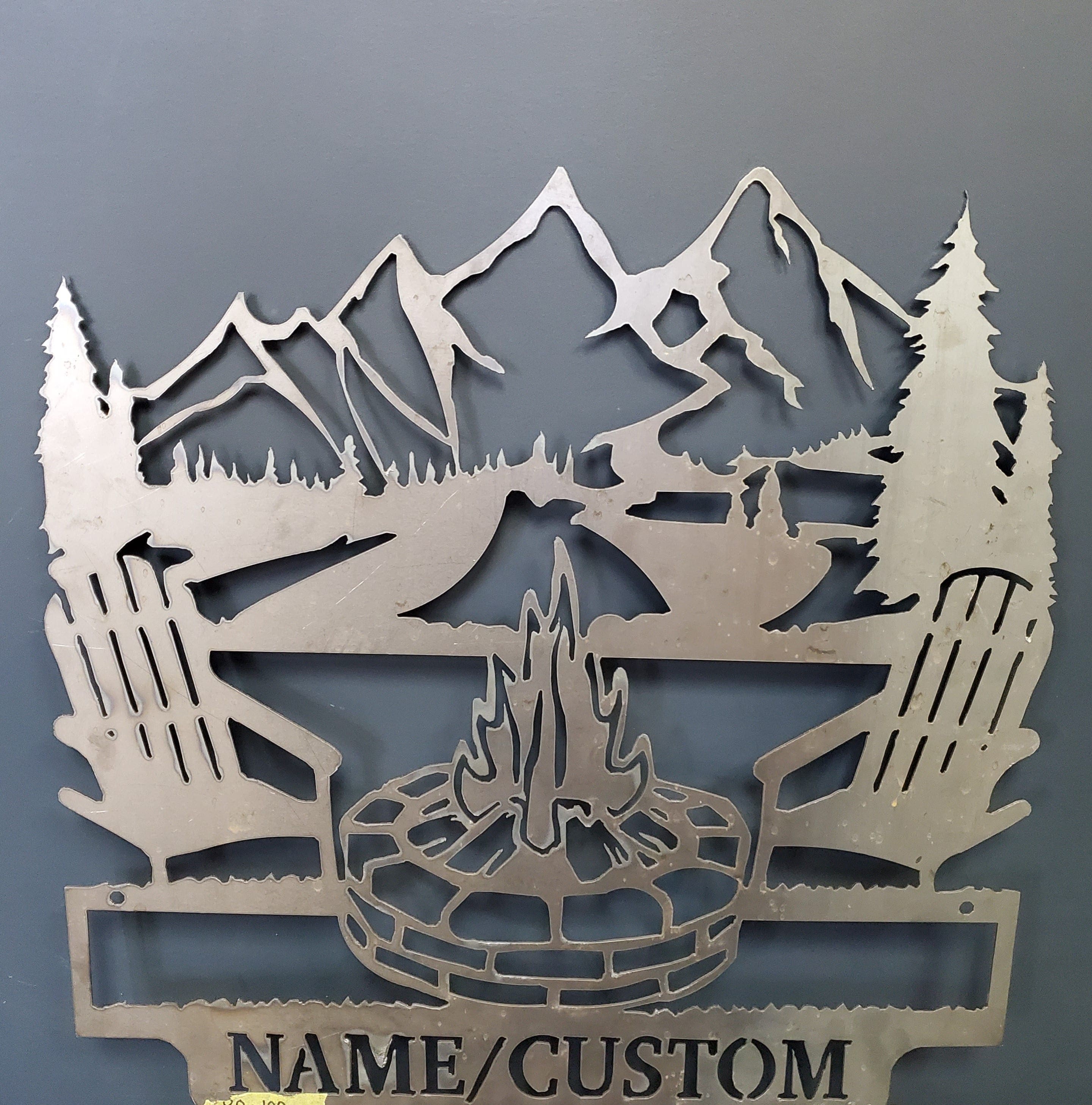 Custom-made metal sign with chairs, mountains and firepit